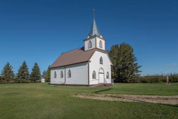 istock Old white church on a sunny day 1339513440