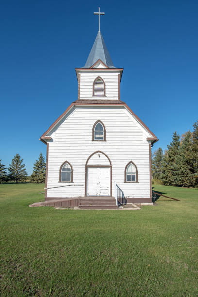 istock Old white church on a sunny day 1339513441