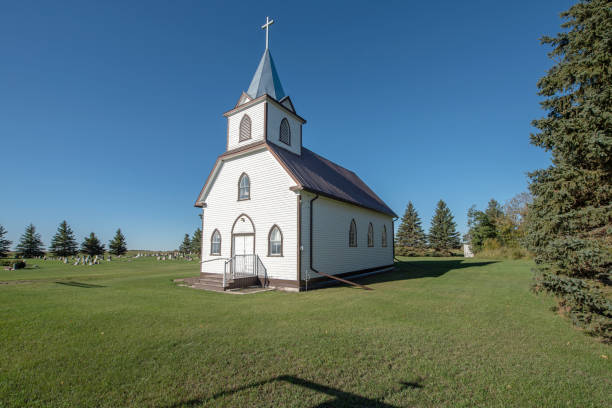 istock Old white church on a sunny day 1339513474