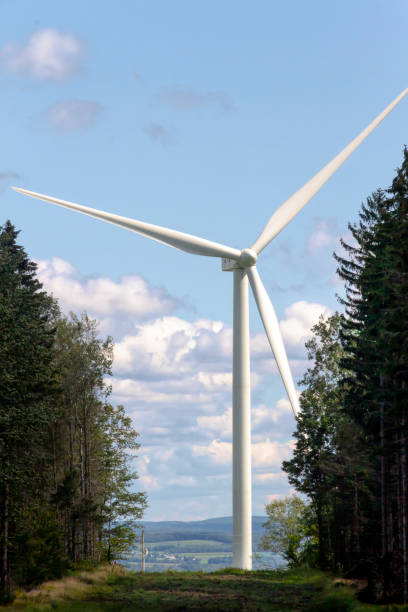 istock Huge Wind Turbine Seen Through Trees 1339516126