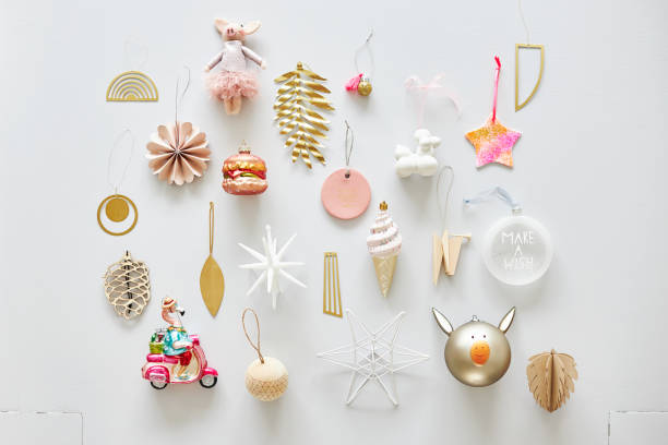 Various modern Christmas tree tags or Christmas tree decorations arranged as a flatlay on a light background