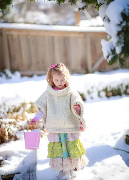Little girl walking in the snow