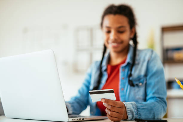 istock Mixed race woman using credit card for online orders during lockdown 1339518157