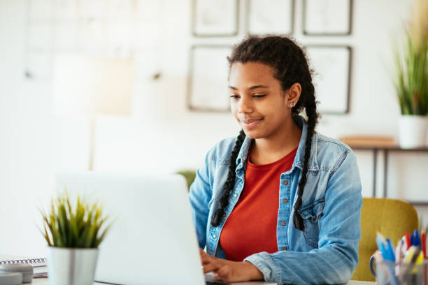 istock Mixed race student studying from home on laptop. Online course during pandemic lockdown 1339518161