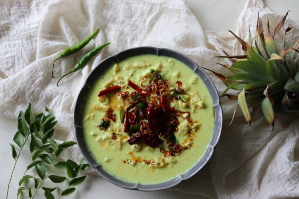 Pineapple pachadi. A yogurt based sweet and spicy curry made with pineapple, coconut, mustard seeds and curd. A side dish for Kerala meals