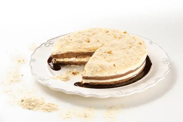 Delicious chocolate and cream pie, with sprinkled nuts, isolated
