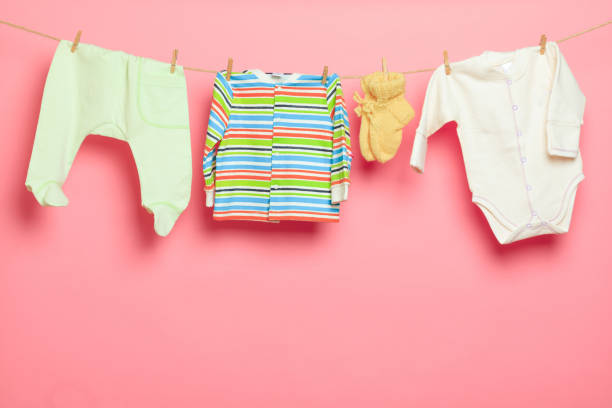 istock Baby clothes on a clothesline on white  background - Image 1339520738