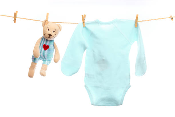 istock Baby clothes on a clothesline on white  background - Image 1339520752