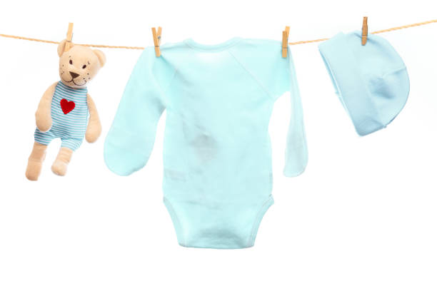 istock Baby clothes on a clothesline on white  background - Image 1339520758
