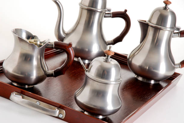istock Silver tea and coffe pots set on a dark wood tray, isolated 1339520966