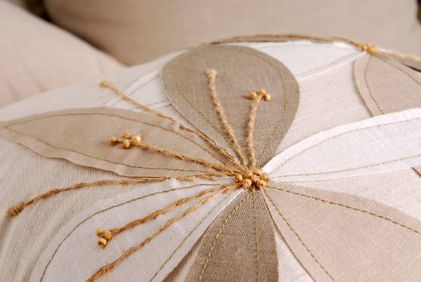 istock Close up of a handmade flower pattern on a beige cushion 1339521025