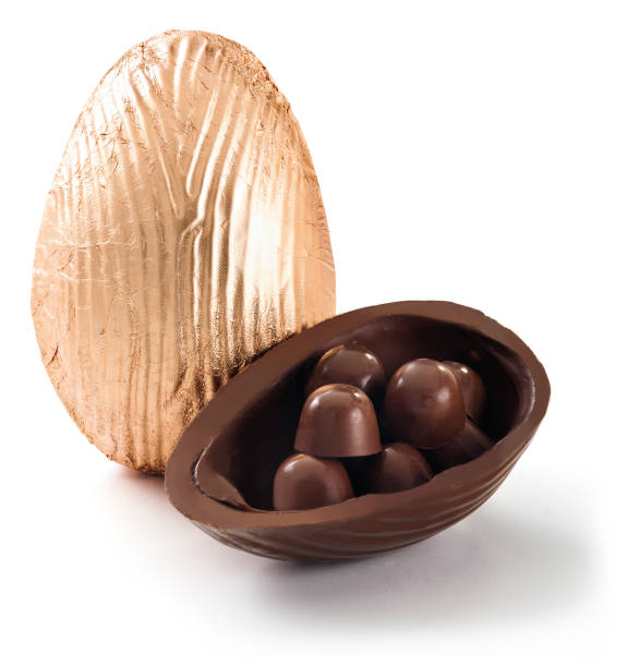 istock Delicious easter egg wrapped in gold tinfoil with bonbons inside, isolated 1339521127