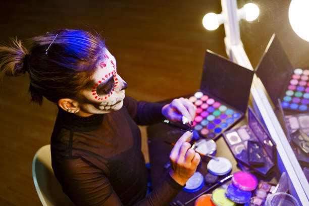 istock Young woman getting ready for Halloween party putting false eyelashes 1339524773