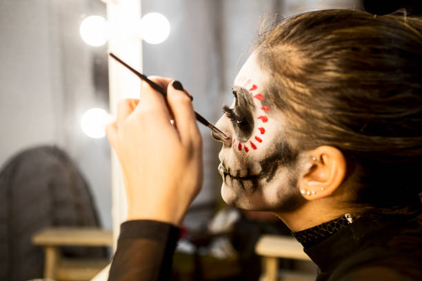 istock Halloween night party is about to begin brushing colors on her face 1339524774
