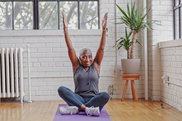 istock Active senior woman doing yoga at home 1339526748