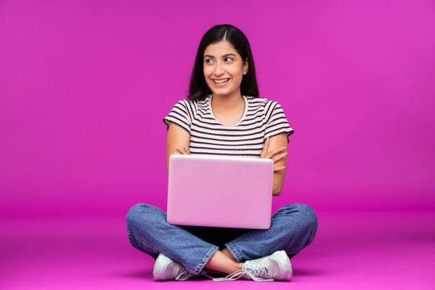 istock Young woman on purple background 1339528002
