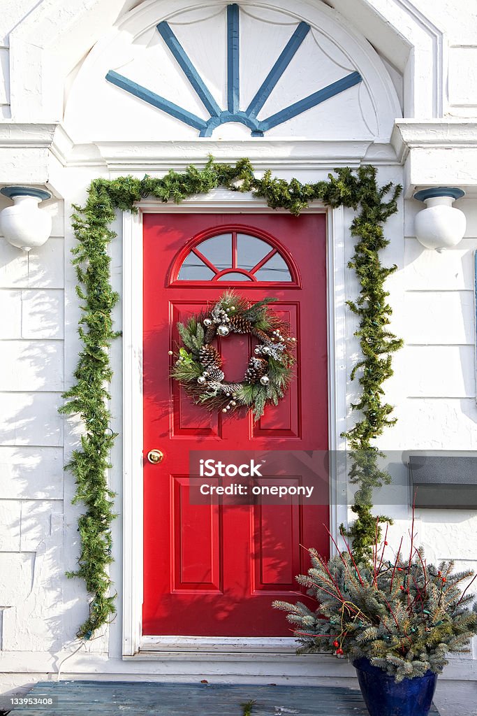 Christmas Door A door of am older home decorated for Christmas. Door Stock Photo