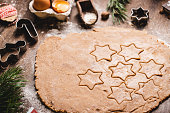 Christmas star shapes on flattened cookie dough in kitchen