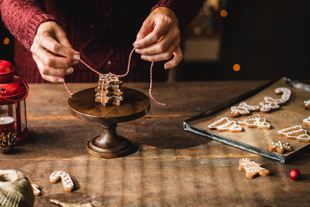 istock Woman tying christmas cookies stack with string on cakestand 1339536778