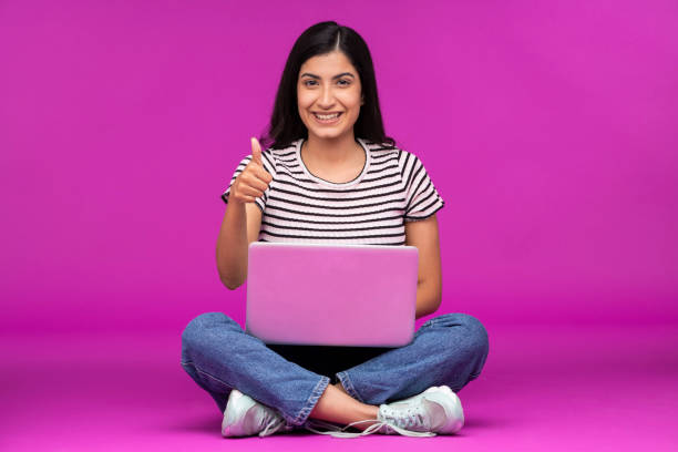 istock Young woman on purple background 1339537857