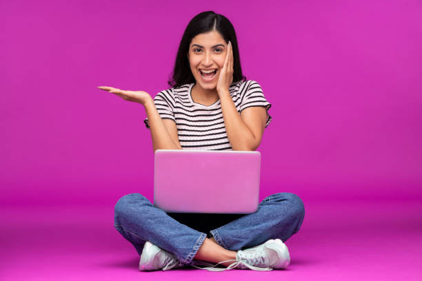 istock Young woman on purple background 1339537885