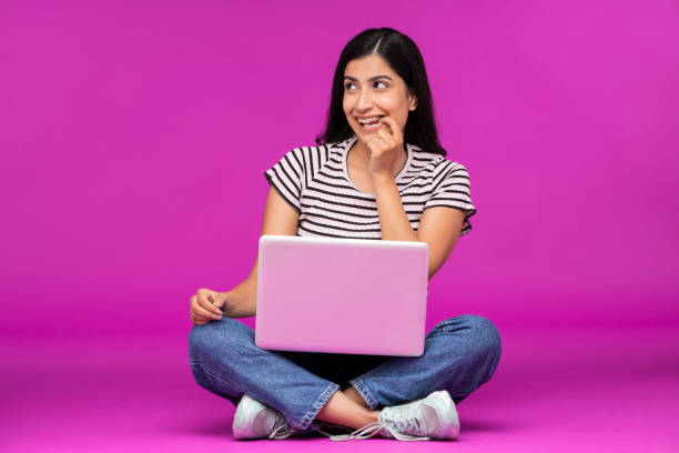istock Young woman on purple background 1339537964