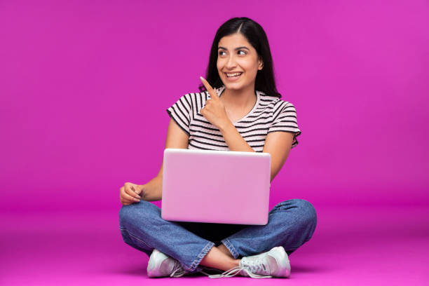 istock Young woman on purple background 1339538121