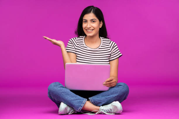 istock Young woman on purple background 1339538238