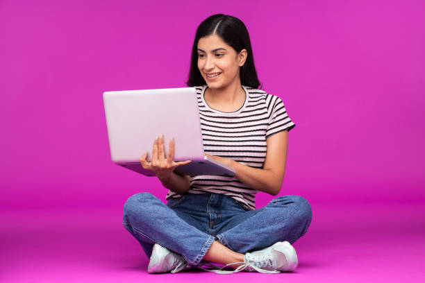 istock Young woman on purple background 1339538778