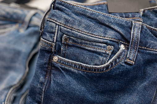 Close-up shot of denim jeans on store shelves