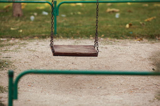 Empty wooden swing in a park