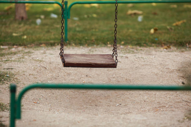 empty swing in a park - swing playground empty abandoned imagens e fotografias de stock
