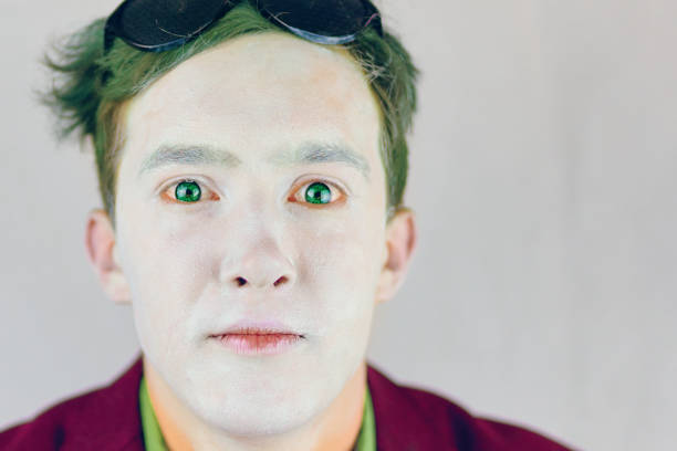 istock Guy with white makeup on face and green hair. 1339543811
