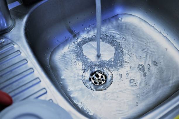 istock Water flowing to kitchen sink 1339543841