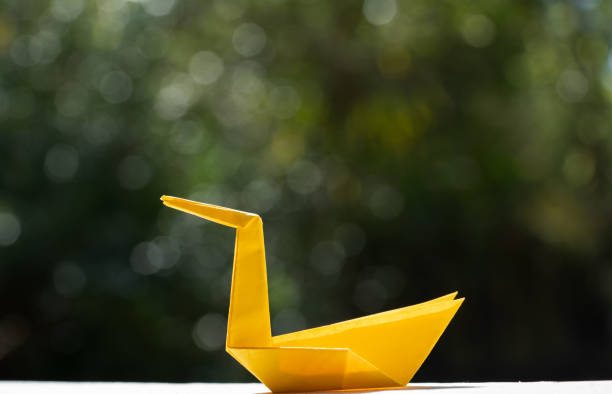 istock Yellow origami bird with background. 1339546581