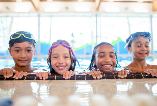istock Multi ethnic group of children learning how to swim 1339552011
