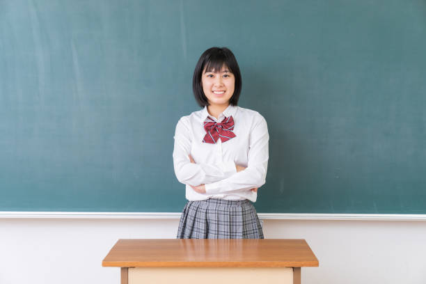 istock young asian school girl,blackboard 1339554655