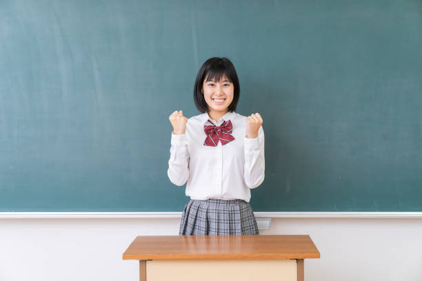istock young asian school girl,blackboard 1339554680