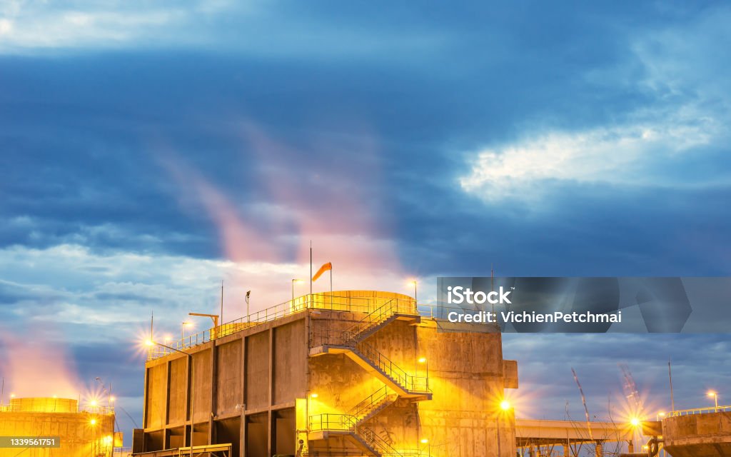 Oil refinery plant form industry,Refinery factory and oil storage tank with sunset Automotive Navigation System Stock Photo