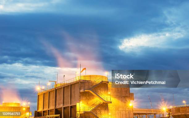 Oil Refinery Plant Form Industryrefinery Factory And Oil Storage Tank With Sunset Stock Photo - Download Image Now