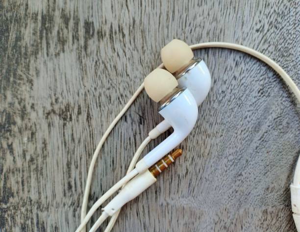 istock white headset on wooden board background 1339568665