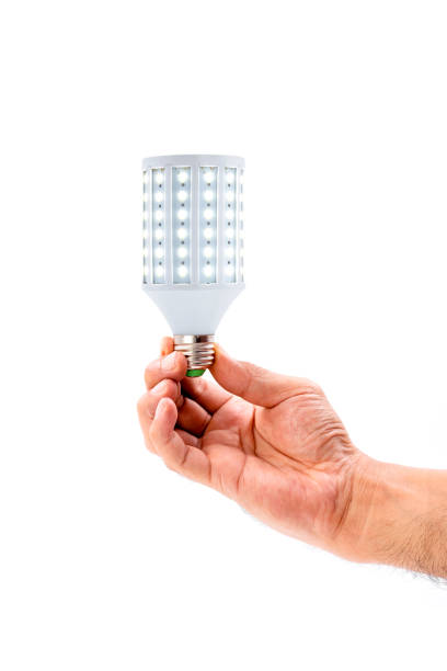 istock Human hand holding LED light bulb on white background. 1339572201