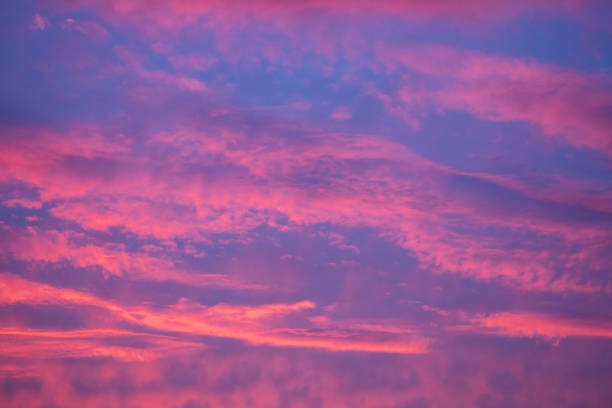 istock Red clouds against a blue sky. Colorful sunset. Abstract background for wallpaper. 1339573738