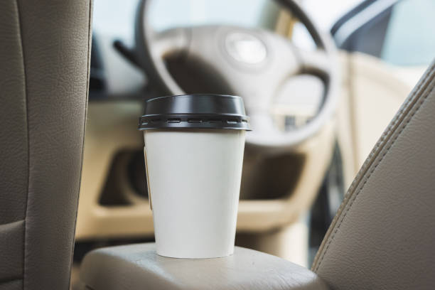 istock A cup of hot coffee put on the car console. Drinking coffee while travel by car. 1339578143