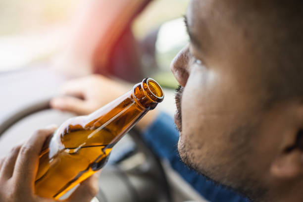 istock Young man drinking beer while driving Risk of accidents due to drunk driving 1339578220