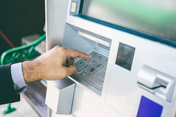 istock Close up male hand using atm machine withdrawal money. Man put the pin code into bank machine to take the money. 1339578249