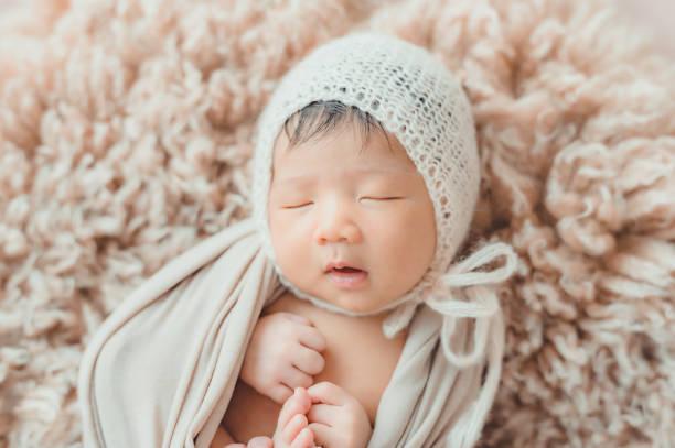 istock Asian newborn baby with knitted hat sleeping 1339579926