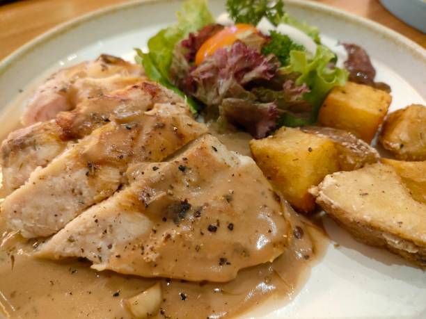 istock Chicken grilled with potatoes and vegetable salad on white flat plate 1339582166