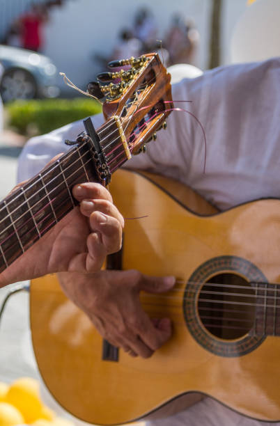 istock Man's Hands Playing The Spanish Guitar 1339583066
