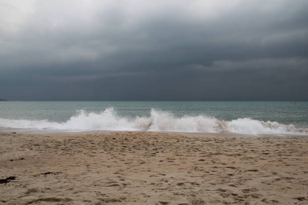 istock wild waves during thunderstorm at the beach with dark clouds at the sky 1339585854